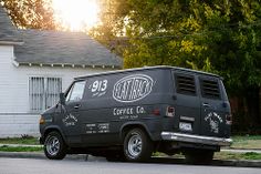 a black van parked in front of a white house with the word ratatoy written on it