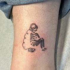 a small tattoo on the ankle of a person with a skull and crossbones