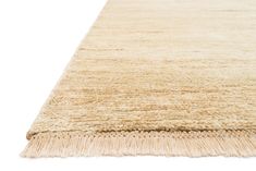 a large beige rug with fringes on the bottom and one long, narrow area