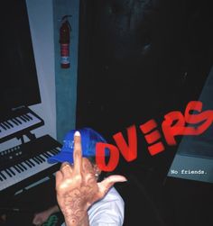 a person with their hand up in front of a keyboard and the word doves written on it