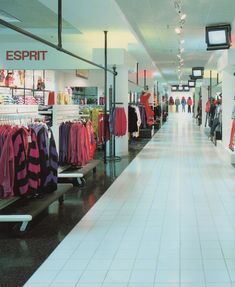 an empty shopping mall filled with lots of clothing