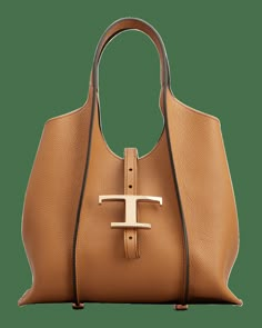 Tod's shopping tote bag in leather  Flat top handle Detachable, adjustable shoulder strap Can be worn as a top handle or shoulder bag  Open top with adjustable T logo center strap Interior, leashed zip pouch bag  Lining: Nylon Feet protect bottom of bag  Approx. 7.6"H x 11.8"W x 4.7"D Made in Italy Tan Shoulder Bag With Gold-tone Hardware, Rich Bags, Handbag Aesthetic, Elegant Shoes Heels, Croc Bag, Minimalist Handbag, Female Bags, Tods Bag, Luxury Tote Bags