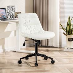 a white office chair sitting in front of a desk with a laptop computer on it