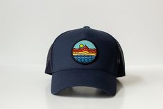 Mountains - Trucker Hat - Navy Blue 65/35 polyester/cotton Mesh back, structured Mid-profile, six-panel Snapback closure Blue Summer Trucker Hat For Travel, Summer Trucker Hat In Blue For Travel, Adjustable Six-panel Spring Hat, Six-panel Baseball Cap For Beach And Summer, Summer Outdoor Hat With Curved Bill, Curved Bill Hats For Summer Outdoor, Blue Flat Brim Snapback Hat For Summer, Navy Hat For Spring, One Size Fits Most, Curved Bill Hat For Summer Outdoor