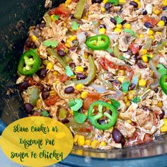 a slow cooker filled with rice, beans, peppers and chicken for mexican food