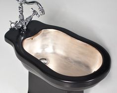 an unusual sink is shown in black and silver