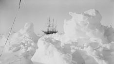 an old black and white photo of a ship in the snow