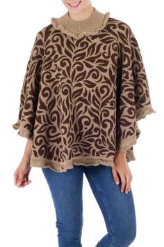 By Waldo Berrios this beautiful poncho is colorful and feminine. Beige and brown foliage is crowned by a snug turtleneck. Both the collar and the hem feature a flirty crocheted lace in beige. The Peruvian designer works in a cozy blend of alpaca wool renowned for its lightweight warmth. One Size Brown Cape For Fall, One-size Brown Cape For Fall, Fall Bohemian Sweater With Crochet Trim, Brown Shawl Cape For Fall, Brown Cozy Cape, Cozy Brown Cape One Size, Cozy One Size Brown Cape, Cozy Brown One-size Cape, Bohemian Beige Poncho For Fall