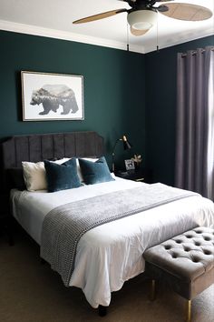 a bedroom with green walls and white bedding