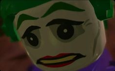 the lego batman movie character is wearing a green and white joker hat with his eyes wide open