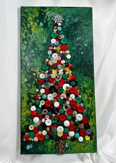 a christmas tree made out of buttons on a canvas