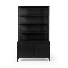 a black bookcase sitting on top of a wooden shelf