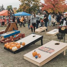 people playing cornhole game at an outdoor event