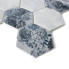 several hexagonal tiles with blue and white flowers on them