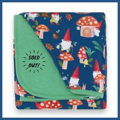 a blanket with gnomes on it and the words sold out printed on it in black