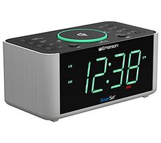 an alarm clock with green numbers on the front and back sides is shown in this image