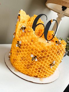 a cake made to look like a beehive with the number 60 on it