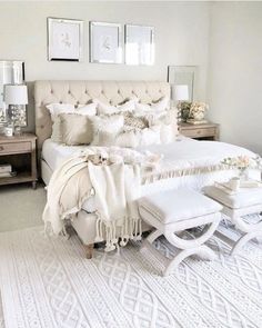 a white bed with pillows and blankets on top of it in a bedroom next to a dresser