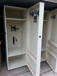 two white storage cabinets with blue handles and hooks