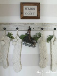 christmas stockings hung on the wall with an old sled