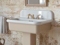 a white sink sitting under a bathroom mirror