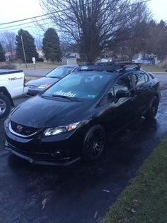 a black car parked on the side of a road