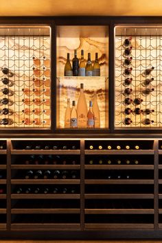 the wine bottles are lined up on the shelves