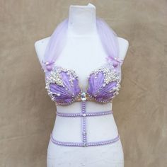 a white mannequin wearing a purple bra