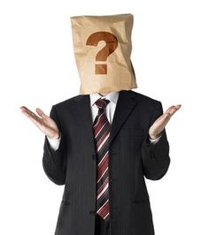 a man wearing a suit and tie with a paper bag over his head