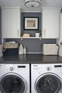 a white washer and dryer sitting next to each other in a laundry room