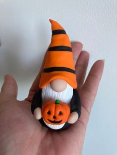 there is a small figurine that has a pumpkin on it's head