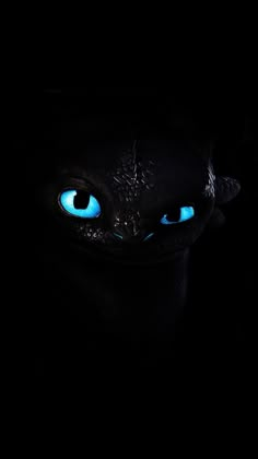 a black background with blue eyes in the dark