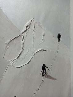 two skiers going up the side of a snow covered mountain with tracks in the snow