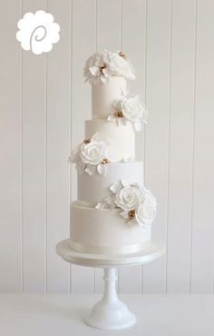 three tiered wedding cake with white flowers on top