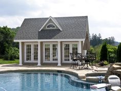 a house with a pool and patio furniture