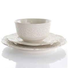 a white cup and saucer sitting on top of each other