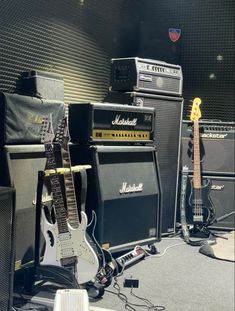 guitars and amps are lined up on the floor