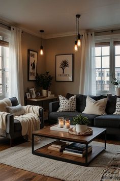 a living room with two couches, a coffee table and some pictures on the wall