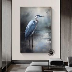 a painting of a blue heron on a wall in a living room with white walls