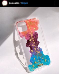 an iphone case with some colorful glitters on it