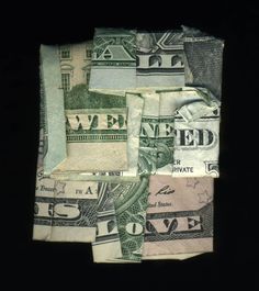 several different types of money sitting on top of each other in a black background with the word we need written across them