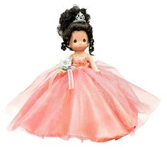 a doll wearing a pink dress with a tiara on it's head and holding a flower in her hand