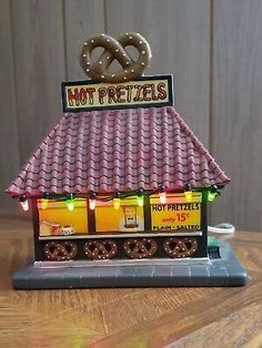 a hot pretzel shop with lights on the roof