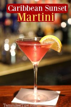 a close up of a martini in a glass on a table with the words, how to make a caribbean sunset martini