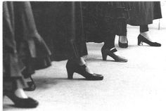 black and white photograph of women's shoes lined up