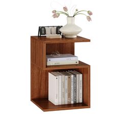 a book shelf with books and a vase on top