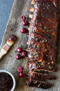 meatloaf with sauce and cherries on a wooden cutting board