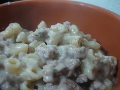 a bowl filled with macaroni and cheese on top of a table