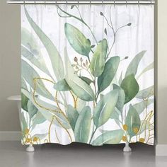 a shower curtain with watercolor leaves and plants on the outside, in front of a bath tub