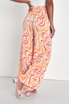 Looking refined and retro is easy to do when you have the Lulus Gettin' Groovy Orange Multi Print Plisse Wide-Leg Pants in your wardrobe! A mesmerizing, swirly multicolored print decorates stretchy and satiny plisse fabric that shapes a high-waisted silhouette and an elasticized waistband that tops breezy, wide leg pants that fall to ankle-length hems. Fit: This garment fits true to size. Length: Floor length. Size small Waist: Fitted - very fitted at natural waist. Hip: Not Fitted - room for hi Plisse Pants, 70s Print, Plisse Fabric, Lulu Fashion, Orange Print, Printed Wide Leg Pants, Pants Pattern, Small Waist, Cool Patterns